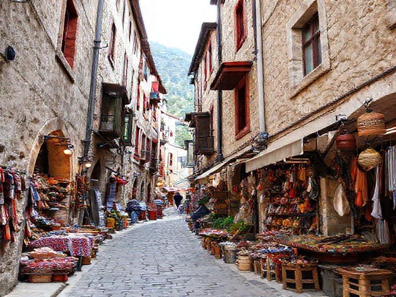 Narrow cobbled street in Kujundziluk bazaar area with artisans